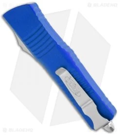 Microtech Combat Troodon OTF Knife D/E Dagger Blue (3.8" Stonewash Full Serr) -Microtech Shop Microtech Combat Troodon DE Auto Blue SW Serr BHQ 98051 jr side