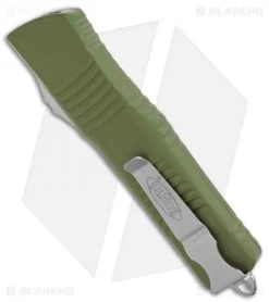 Microtech Combat Troodon OTF D/E Knife OD Green (3.8" Satin Full Serr) 142-6OD -Microtech Shop Microtech Combat Troodon OTF DE Auto OD Green Satin Full Serr 142 6OD BHQ 50395 jr side