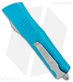 Microtech Combat Troodon OTF Knife D/E Dagger Turquoise (3.8" Satin Serr) -Microtech Shop Microtech Combat Troodon OTF DE Dagger Turquoise Satin Serr 142 5TQ BHQ 98094 jr side 1